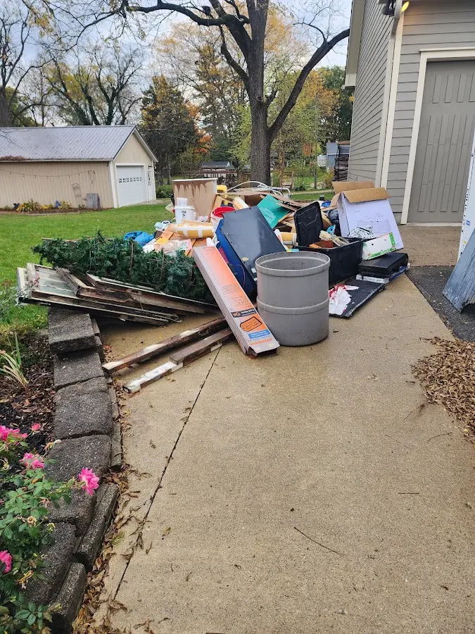 Dumpster being loaded with debris for Commercial Dumpster Rental in Paxton